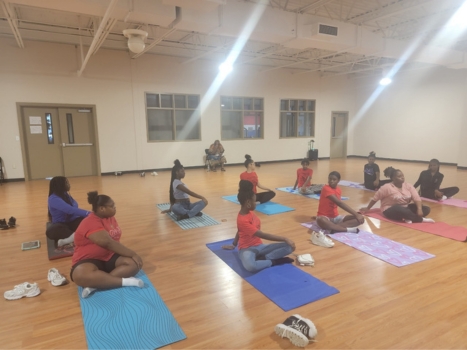 a group of people participating in a fitness class at the PALW